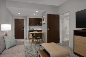 a living room with a couch and a table at Homewood Suites Mobile in Mobile