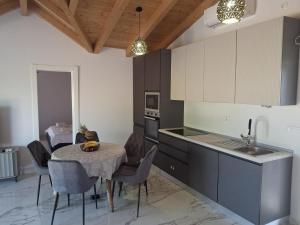 a kitchen with a table and chairs and a sink at Vila Nikola in Pučišća