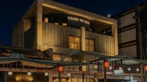 a large building at night with some red traffic lights at Kizashi The Suite Kyoto Gion in Kyoto