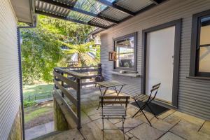 a patio with a table and chairs on it at Comfort Resort Leura Gardens in Leura