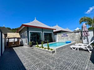 a house with a swimming pool and a patio at N&D Poolvilla in Ao Nang Beach