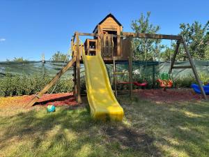 a playground with a slide in the grass at Hobbit House in Tsarichino