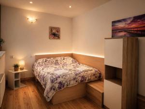 a small bedroom with a bed in a room at Hobbit House in Tsarichino +10 photos