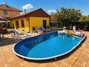 a swimming pool with inflatable toys in a backyard at Hobbit House in Tsarichino