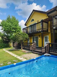 a house with a swimming pool in front of it at Honey Bear Pension in Pyeongchang