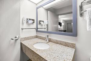 a bathroom with a sink and a mirror at Quality Inn Albany in Albany +95 photos