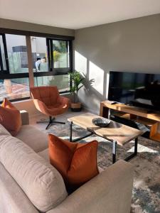 a living room with a couch and a table at Mount Glow Self-Catering in Swellendam