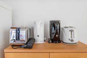 a shelf with various appliances on top of a cabinet at Gite La Chambrette in Blieux