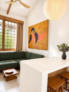 a living room with a couch and a table at Haku - Japandi Village in General Luna