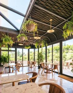 a restaurant with tables and chairs and windows at Passeio Sintra Collection in Sintra