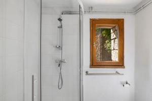 a shower with a window in a bathroom at Gite La Chambrette in Blieux +30 photos