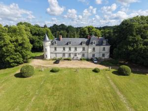 an aerial view of a large white house on a field at Gîte de LA CHESNAYE in Cerelles