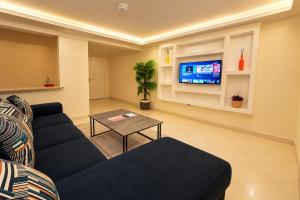 a living room with a couch and a tv at COMFORT E SUITES in Nairobi