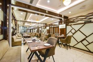 a restaurant with tables and chairs in a room at Pineberry Hotels - Near Golden Temple in Amritsar