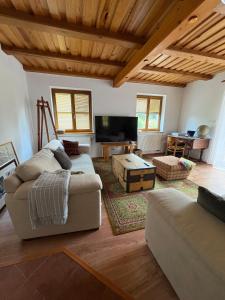 a living room with a couch and a table at Šumavský dům in Drslavice