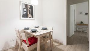 a dining room table and chairs with a white table and ahibition at Italianway-Veniero 8 in Milan