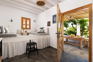 a room with a bed and a table and a window at Ktima Natura in Archangelos +14 photos