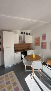 a kitchen with a table and chairs in a room at Le cocon du pas de Lauzens in Aouste-sur-Sye