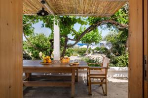 a wooden table with fruit on it on a patio at Ktima Natura in Archangelos