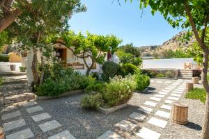 a garden with some plants and a building at Ktima Natura in Archangelos