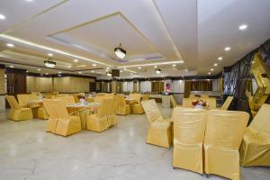 a banquet hall with yellow chairs and tables at Pineberry Hotels - Near Golden Temple in Amritsar