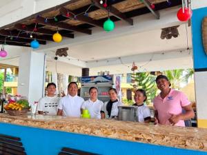a group of people standing at a bar at Azure Camotes Resort Hotel in Camotes Islands +58 photos