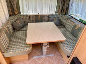 a table in the back of a bus with chairs at Campinplatz Margarethenruh in Nordstrand +10 photos