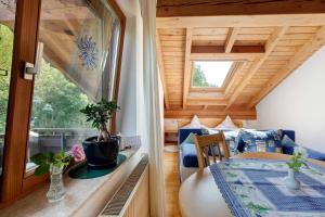 a room with a table and a window in a tiny house at Ferienwohnungen Im Försterhaus in Lonsee