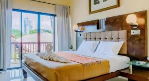 a bedroom with a large bed and a balcony at Lotusland Resort in Jomtien Beach +104 photos