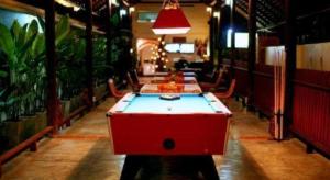 a room with a pool table in a room with plants at Lotusland Resort in Jomtien Beach