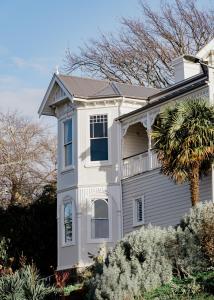 a white house with a tree in front of it at Wahroonga on Bourke in Launceston