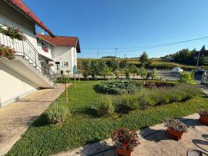 a garden in front of a house with plants at Bijeli Cvijet in Glamočani