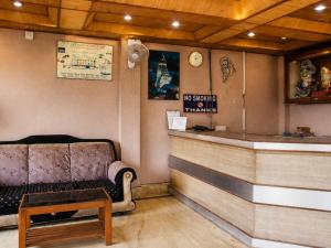 a waiting room with a couch and a counter at Hotel Dreamland Mandarmani in Mandarmoni