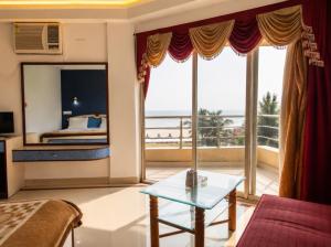 a hotel room with a view of the ocean at Hotel Dreamland Mandarmani in Mandarmoni +21 photos