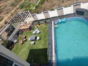 an overhead view of a swimming pool with a table and chairs at The Heritage villa in Udaipur