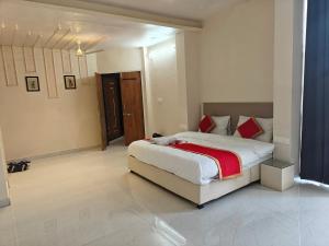 a bedroom with a large bed with red pillows at The Heritage villa in Udaipur +6 photos