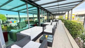 a row of chairs and tables in a building at AN Hotel Milano Melegnano in Carpiano