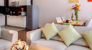 a living room with a couch and a table at Oak Chateau in Jinzhou