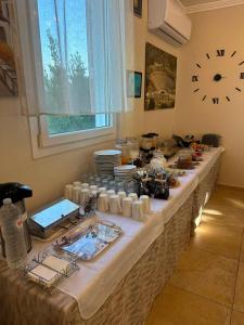 a long table with plates and dishes on it at Anestis Studios in Lidia