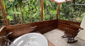 a bathroom with a tub and a chair and a toilet at Villa De View in Ban Tham +148 photos