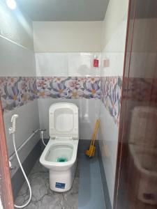 a small bathroom with a toilet in a stall at vMAC in Thiruchendur