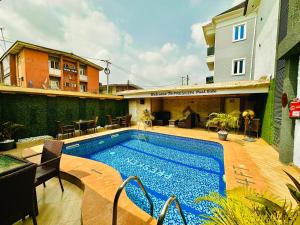 a swimming pool in the middle of a building at Presken Hotel Mojidi, Allen Ikeja in Ikeja