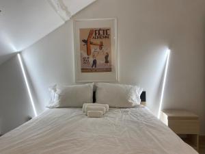 a white bed with a white pillow on top of it at Le Petit Canivet in Cerny