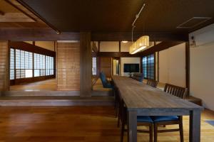 a dining room with a long table and chairs at つむぎ in Shimoda