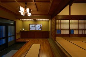 an empty room with a chandelier in a building at つむぎ in Shimoda
