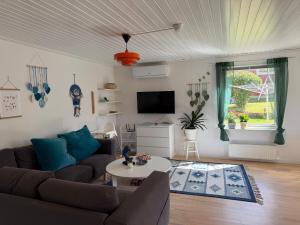 a living room with a couch and a table at Charmig Villa bredvid sjön Örlen in Tibro