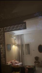 a reflection of a room with a bed and a mirror at house in rafraf beach in Rafrāf