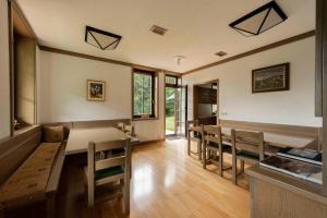 a kitchen and dining room with a table and chairs at Karami Mountainhouse in Tržič