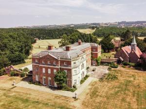 an aerial view of a large brick building on a field at Kyre Park in Tenbury