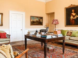 a living room with a table with books on it at Kyre Park in Tenbury